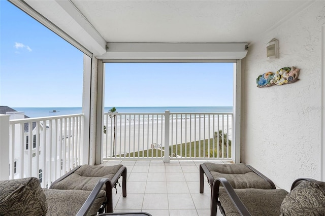 balcony featuring a water view and a view of the beach