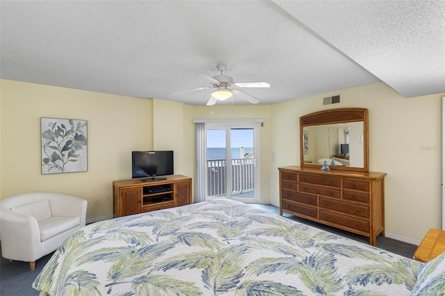 carpeted bedroom featuring a textured ceiling, visible vents, baseboards, a ceiling fan, and access to outside