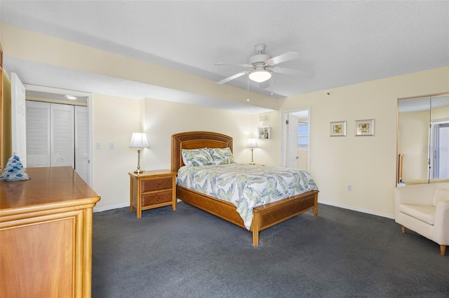 bedroom with a ceiling fan, dark colored carpet, a textured ceiling, and baseboards