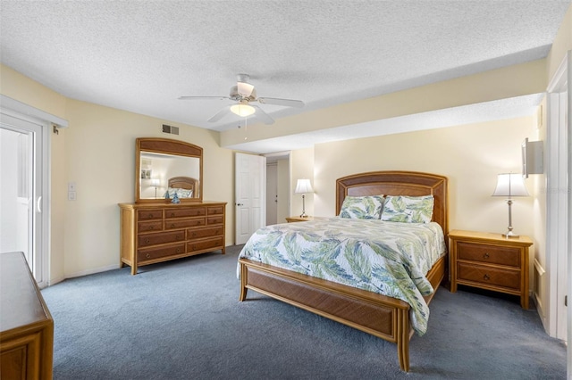 bedroom with carpet floors, visible vents, ceiling fan, and a textured ceiling