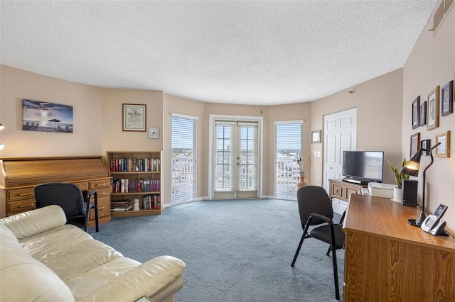 carpeted office with visible vents, a textured ceiling, and french doors