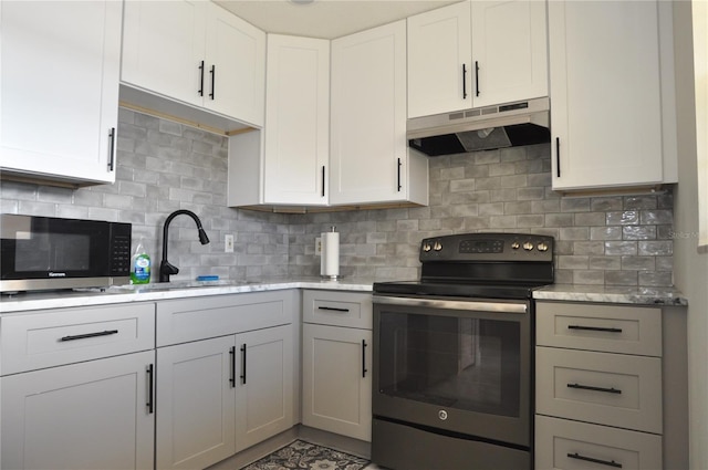 kitchen featuring stainless steel range with electric stovetop, backsplash, sink, and white cabinets