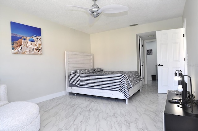 bedroom with a textured ceiling and ceiling fan