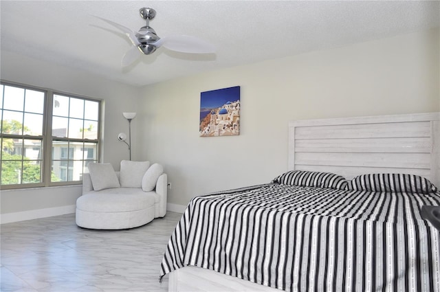bedroom with a textured ceiling and ceiling fan