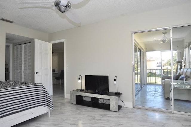 bedroom with a textured ceiling, access to outside, a closet, and ceiling fan