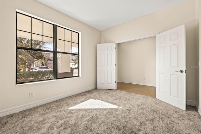 unfurnished bedroom with light colored carpet