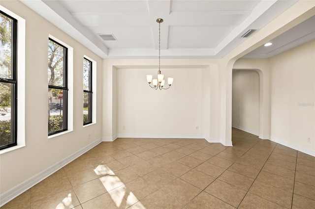 unfurnished dining area with coffered ceiling, a chandelier, light tile patterned floors, and a wealth of natural light