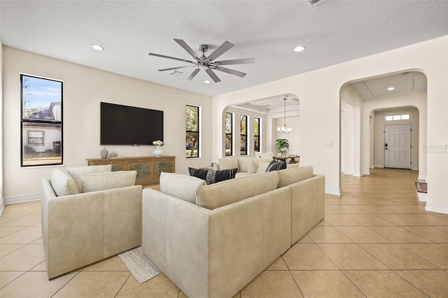 living room featuring light tile patterned floors, plenty of natural light, and a textured ceiling