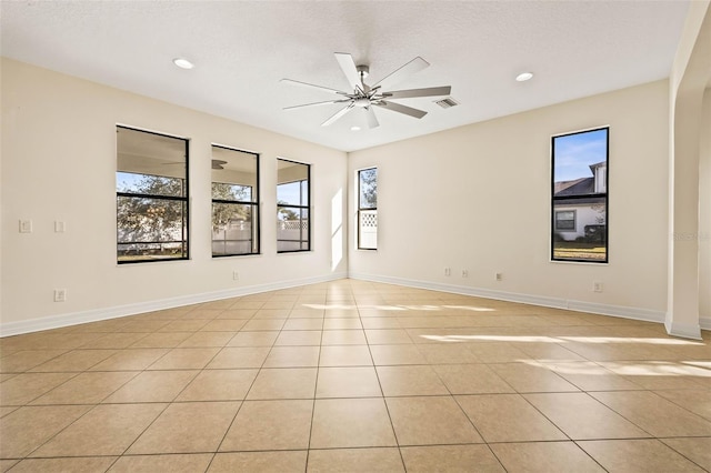 unfurnished room featuring light tile patterned floors, a textured ceiling, and ceiling fan