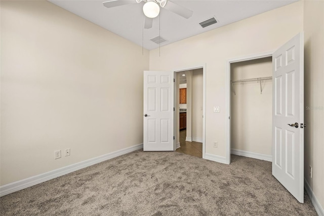 unfurnished bedroom with carpet floors, a closet, and ceiling fan