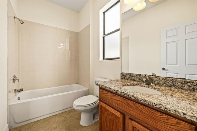 full bathroom with vanity, tiled shower / bath combo, tile patterned floors, and toilet