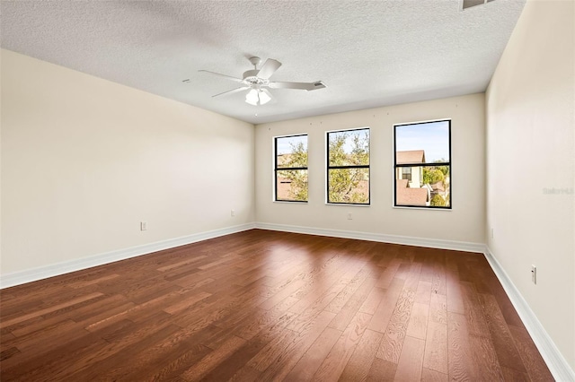 unfurnished room featuring dark wood-type flooring, ceiling fan, and a textured ceiling