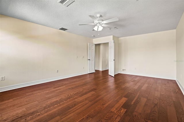 unfurnished room featuring a textured ceiling, dark wood-type flooring, and ceiling fan