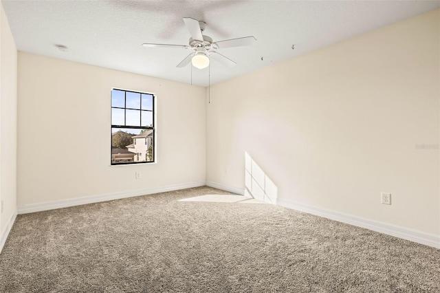 spare room featuring a textured ceiling, carpet floors, and ceiling fan