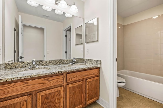 full bathroom featuring tiled shower / bath, tile patterned floors, toilet, and vanity