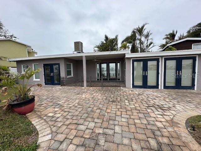 back of property featuring central AC unit and french doors