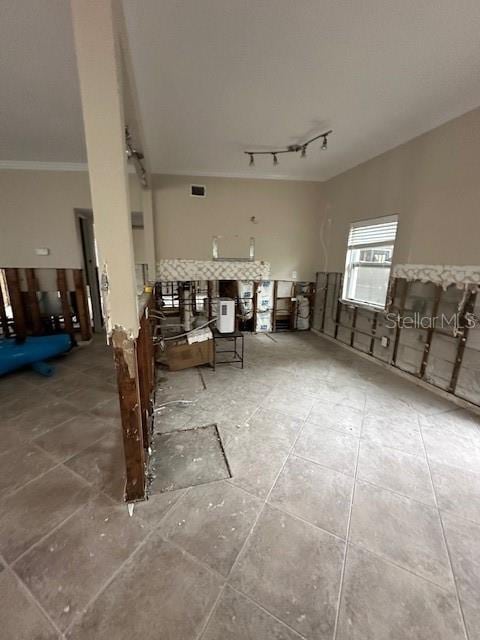 interior space with crown molding and rail lighting