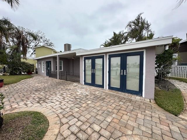 rear view of house with central air condition unit and french doors