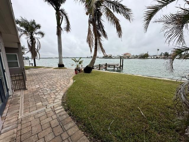 exterior space with a water view and a boat dock