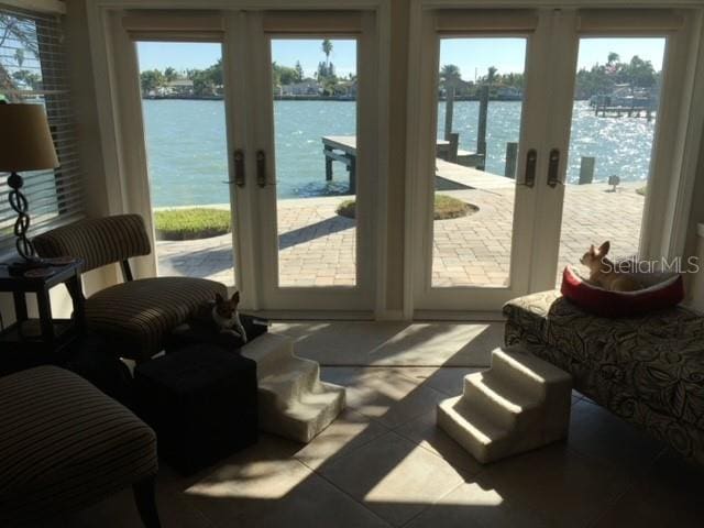 entryway with a water view, plenty of natural light, and french doors