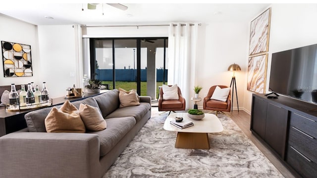 living room featuring ceiling fan and light wood-type flooring