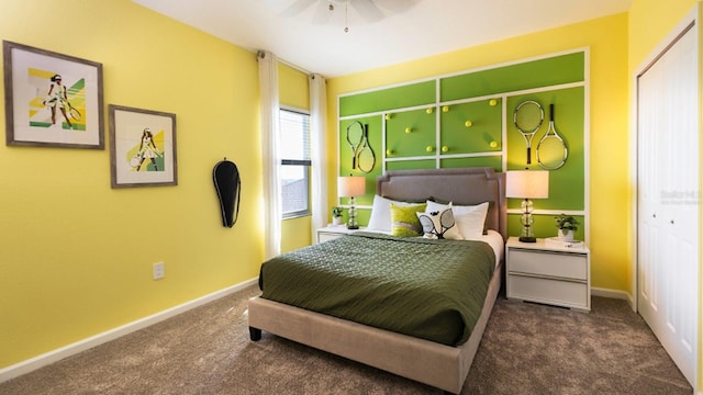 carpeted bedroom with ceiling fan and a closet