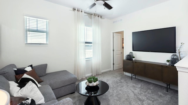 carpeted living room featuring a wealth of natural light and ceiling fan