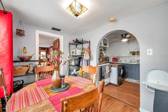 dining space featuring ceiling fan and light wood-type flooring