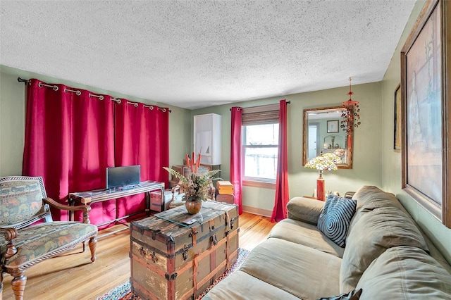 living room featuring a textured ceiling and light wood-type flooring