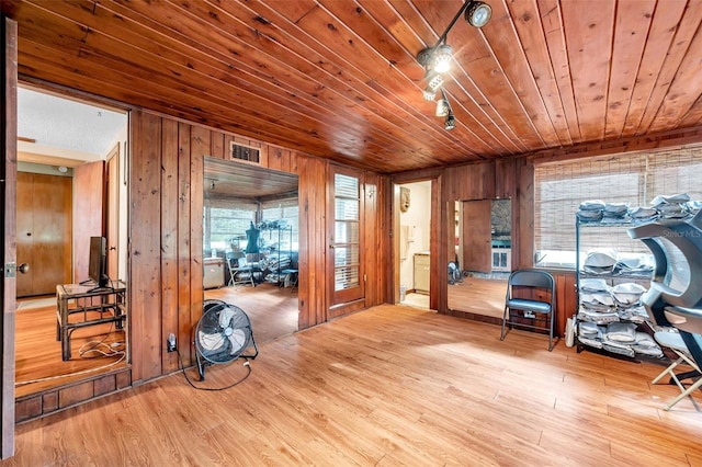 interior space featuring wood-type flooring, plenty of natural light, wood ceiling, and wood walls