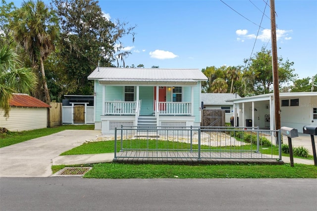 view of front of house with a storage unit and covered porch