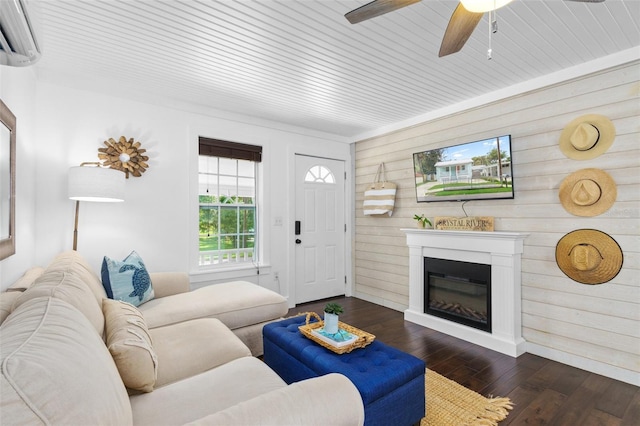 living room featuring wood ceiling, dark wood-type flooring, ceiling fan, an AC wall unit, and wood walls