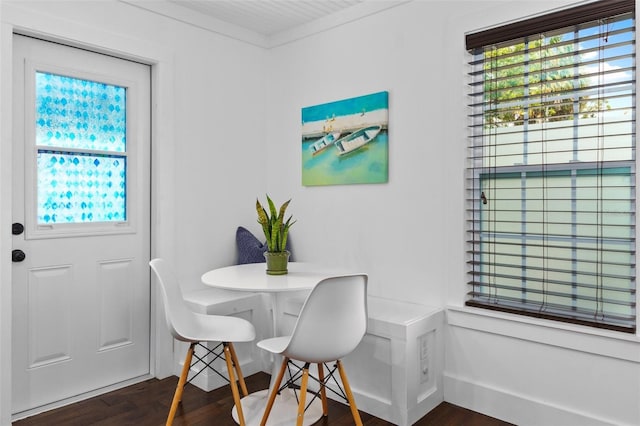 dining area featuring crown molding, dark hardwood / wood-style floors, and breakfast area