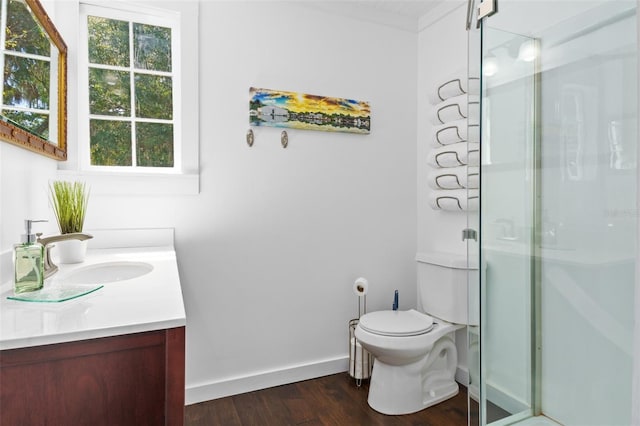 bathroom featuring hardwood / wood-style flooring, vanity, walk in shower, and toilet