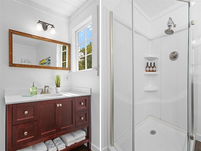 bathroom featuring vanity and a shower with shower door