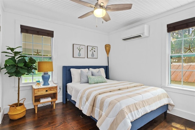 bedroom featuring multiple windows, an AC wall unit, and ceiling fan