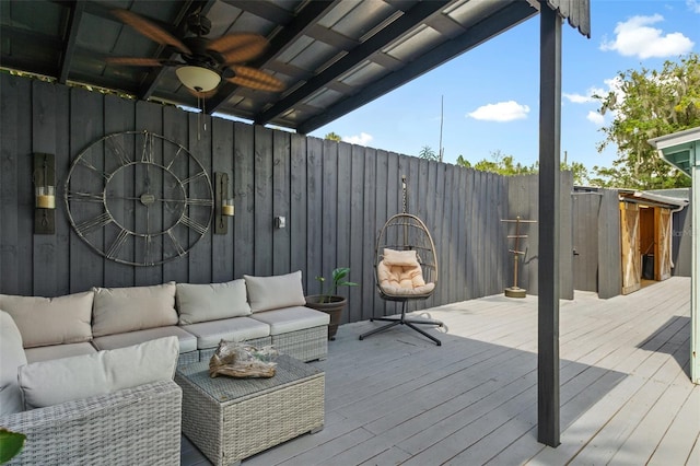 wooden deck featuring outdoor lounge area and ceiling fan