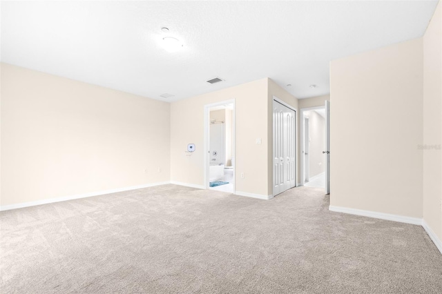 spare room with light colored carpet