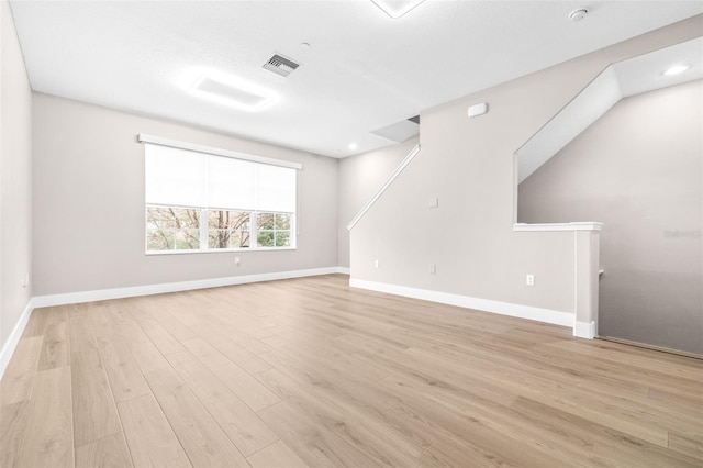 spare room featuring light wood-type flooring