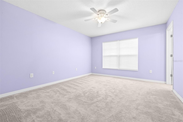 spare room with ceiling fan and carpet flooring