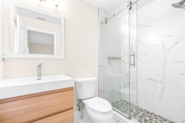 bathroom with walk in shower, vanity, and toilet