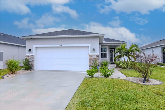 view of front of home with a garage and a front lawn