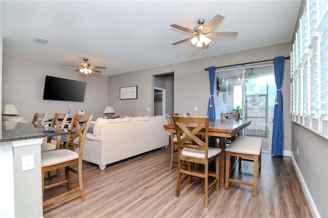 dining area featuring ceiling fan and light wood-type flooring