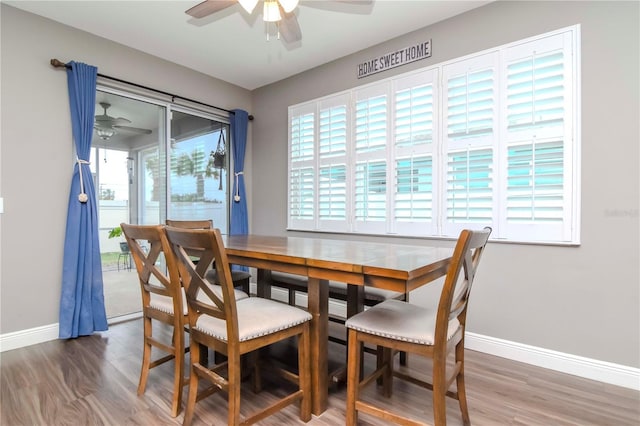 dining room featuring wood-type flooring and ceiling fan