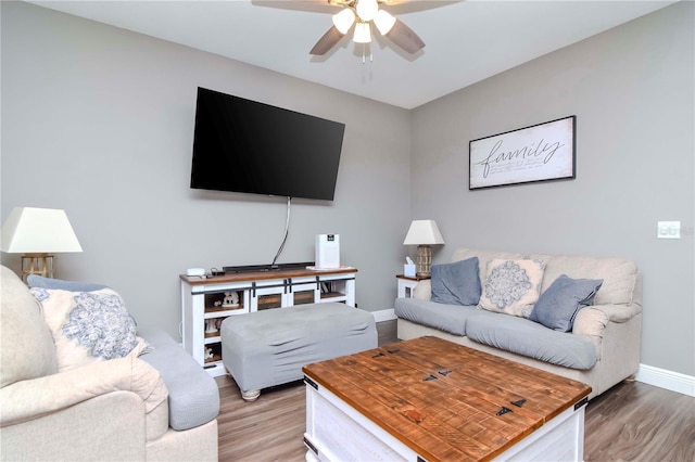 living room featuring wood-type flooring and ceiling fan