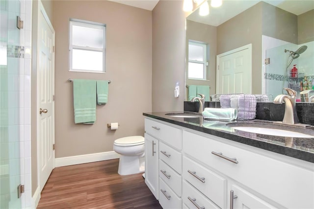 bathroom with vanity, hardwood / wood-style floors, an enclosed shower, and toilet