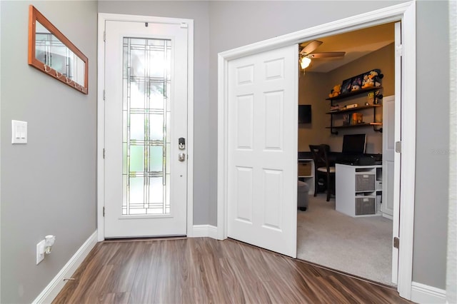 doorway to outside featuring ceiling fan and carpet