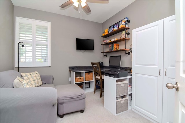 carpeted office space with ceiling fan