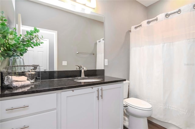 bathroom featuring vanity, toilet, and hardwood / wood-style floors