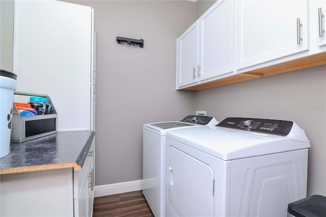 clothes washing area with cabinets, dark hardwood / wood-style flooring, and washing machine and dryer